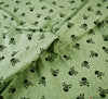 Cotton Jersey Fabric - Marl Skulls & Crossbones - Sage Green